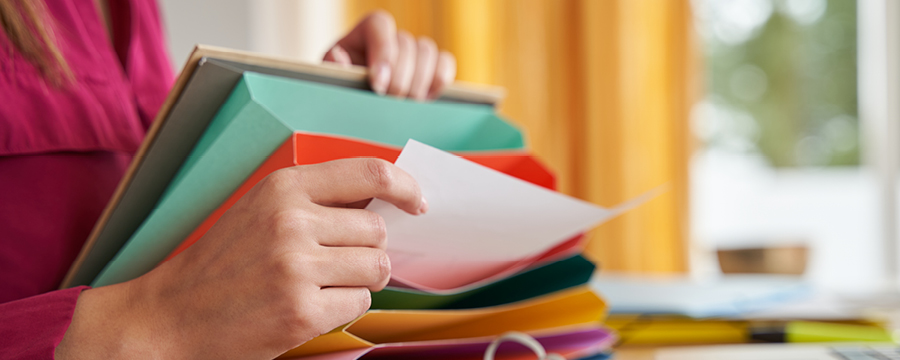 Person organizing papers in folders