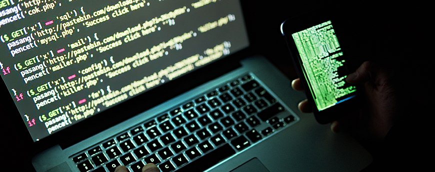 Code on a laptop and phone